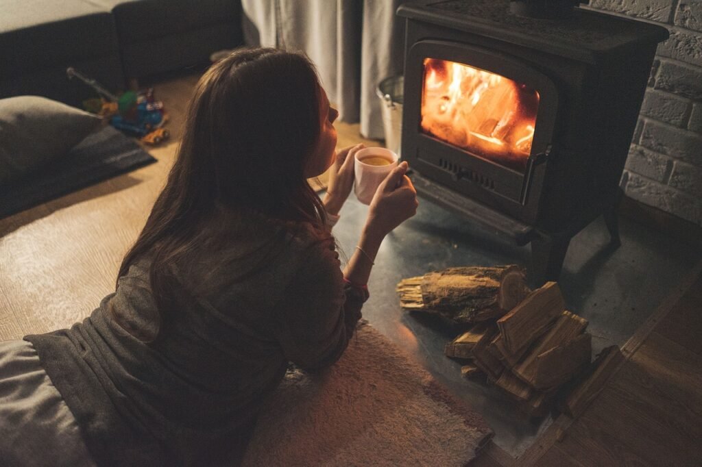 Person holding hot chocolate near a stove