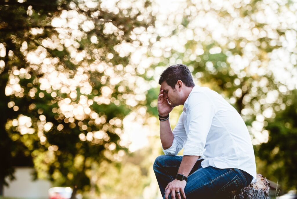 Man sitting down appears to regret something