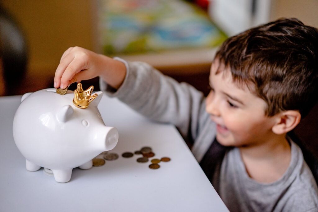 Child placing coins in a piggy bank