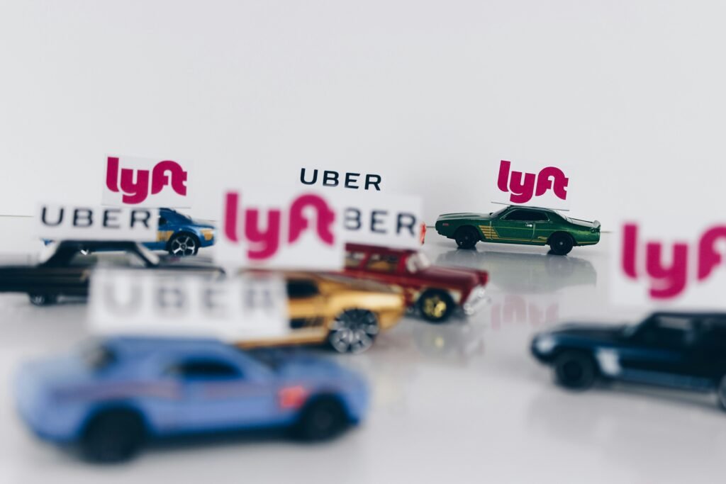 Child's toy cars with Lyft and Uber signs above them